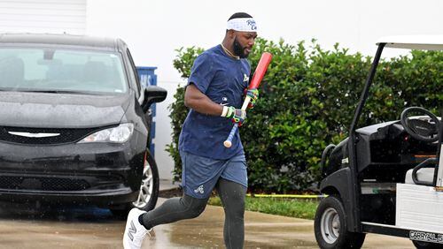 Atlanta Braves center fielder Michael Harris II rushes to an indoor facility on a rainy day of spring training workouts at CoolToday Park, Sunday, Feb. 18, 2024, in North Port, Florida. (Hyosub Shin / Hyosub.Shin@ajc.com)