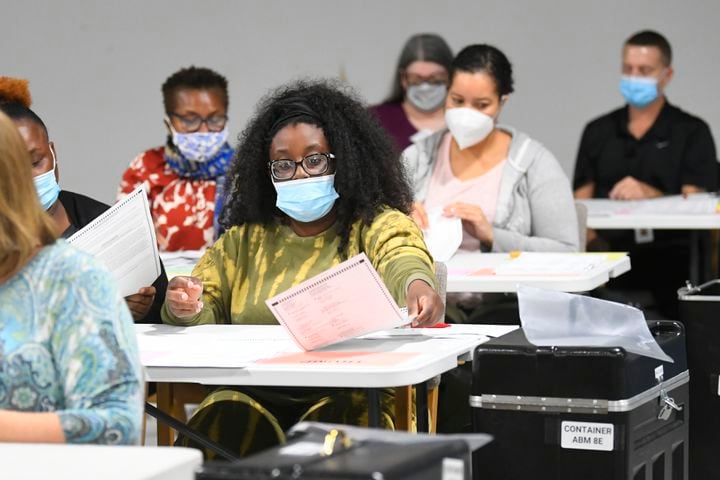 An election worker counts ballots as votes for President are recounted at the Gwinnett County elections office on Friday, Nov.13, 2020 in Lawrenceville. (JOHN AMIS FOR THE ATLANTA JOURNAL-CONSTITUTION)