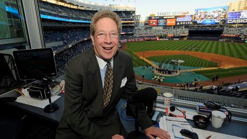 FILE - New York Yankees broadcaster John Sterling sits in his booth before a baseball game against the Boston Red Sox at Yankee Stadium in New York, Sept. 25, 2009. Sterling announced his immediate retirement Monday, April 15, 2024, at age 85 a few weeks into his 34th season in New York's broadcast booth. (AP Photo/Bill Kostroun, File)
