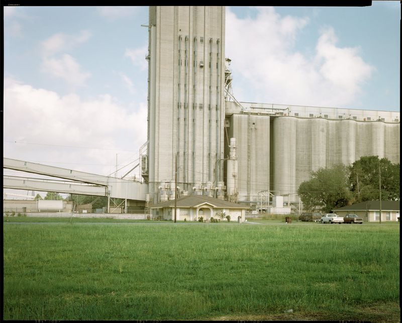 "Home and Grain Elevator, Destrehan, Louisiana," (1998) by Richard Misrach whose "Picturing the South" project documented Southerners, often in poor and Black communities, living next to petrochemical factories in Louisiana's "Cancer Alley."
Courtesy of Richard Misrach
