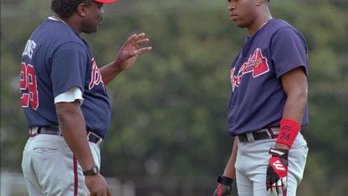 Batting coach Clarence Jones (left) talks with Braves outfielder Jermaine Dye  during training camp in 1997. (File photo)
