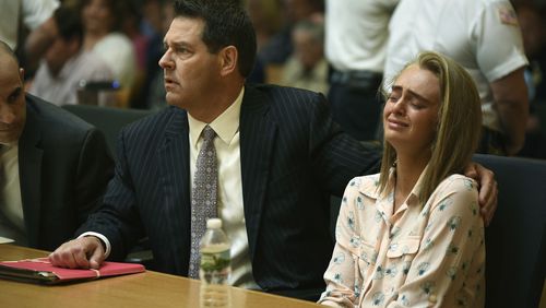 Michelle Carter, right, seated with her attorneys Cory Madera, left, and Joseph Cataldo reacts as she listens to Judge Lawrence Moniz before he finds her guilty of involuntary manslaughter in the suicide of Conrad Roy III, Friday, June 16, 2017, in Bristol Juvenile Court in Taunton, Mass. (Glenn C.Silva/Fairhaven Neighborhood News, Pool)