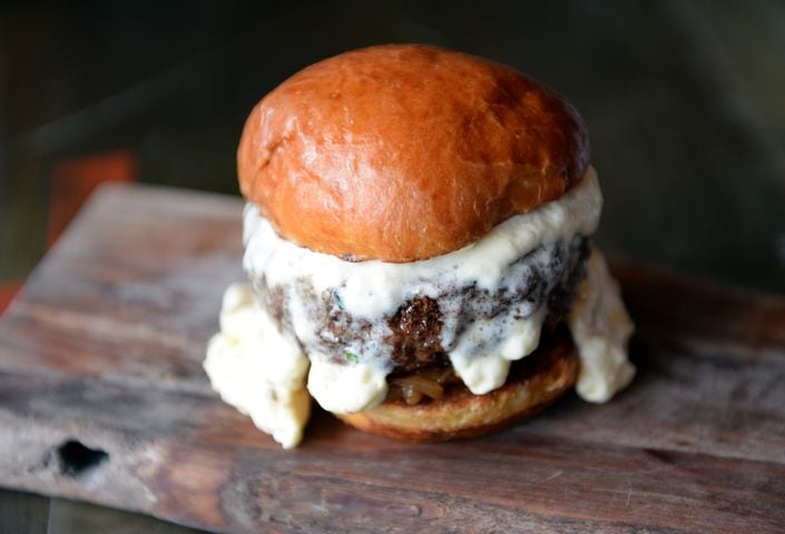 Burger with candied onions, braised bacon and cheddar foam