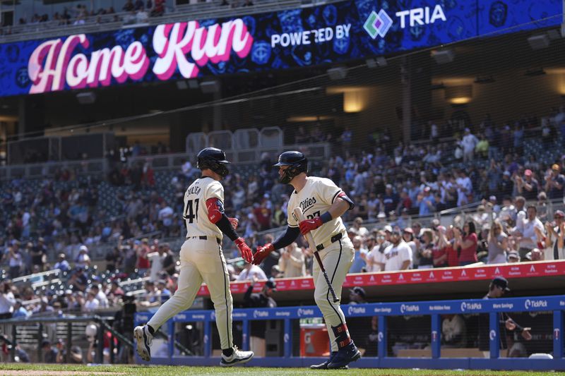 Minnesota Twins' Edouard Julien, left, celebrates with Ryan Jeffers after hitting a solo home run during the sixth inning of a baseball game against the Chicago White Sox, Thursday, April 25, 2024, in Minneapolis. (AP Photo/Abbie Parr)