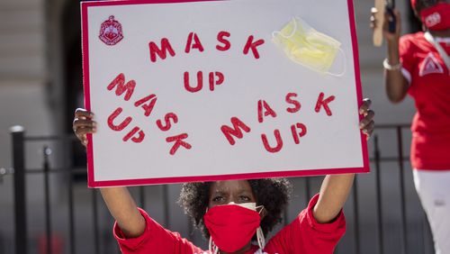 07/23/2020 - Atlanta, Georgia - A member of the Delta Sigma Theta Sorority, Inc. holds a sign during a solidarity protest to show support for Atlanta Mayor Keisha Lance Bottoms outside of the Georgia State Capitol Building, Thursday, July 23, 2020. Gov. Brian Kemp issued a lawsuit against the Atlanta mayor due to her push to move her city back to phase 1 of reopening. (ALYSSA POINTER / ALYSSA.POINTER@AJC.COM)