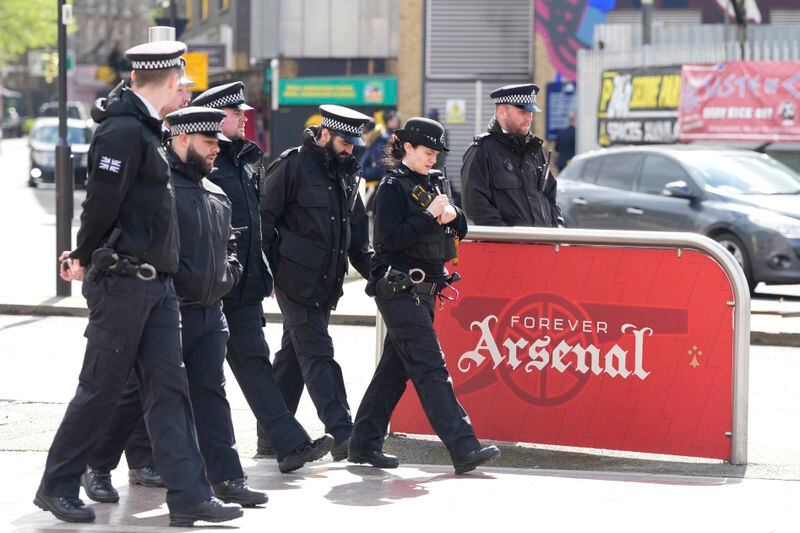 Police arrive to patrol outside Arsenal's Emirates Stadium ahead of the Champions League quarterfinal 1st leg soccer match between Arsenal and Bayern Munich in London, Tuesday, April 9, 2024. This week's Champions League soccer games will go ahead as scheduled despite an Islamic State terror threat. (AP Photo/Frank Augstein)