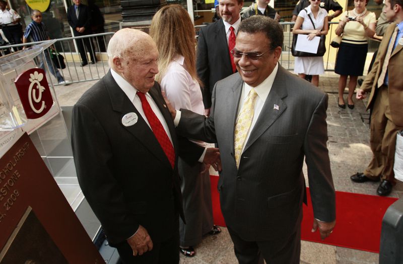 Truett Cathy and former Atlanta Mayor and U.N. Ambassador Andy Young celebrate a philanthropic milestone in 2009, when Chick-Fil-A doanted $1.4 million in scholarships to employees. This year the Chick-fil-A Foundation awarded $14.5 million in scholarships. AJC file photo/John Spink