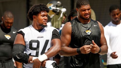Jacksonville Jaguars defensive end Dawuane Smoot (94) and Calais Campbell (right) walk off of the field following mandatory minicamp OTA's at Ever Bank field.
