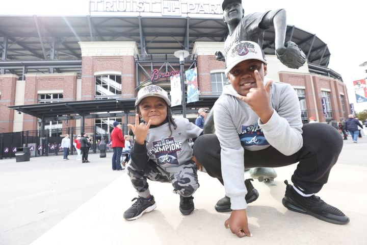 Karter and Kevin Andrews from Dekalb county poses outside of the Truist Stadion, ready to celebrate the Atlanta Braves the World Series 2021 on Friday, November 5, 2021.Miguel Martinez for The Atlanta Journal-Constitution