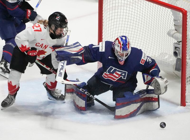 United States goaltender Aerin Frankel (31) makes a save over Canada's Emma Maltais (27) during the first period in the final at the IIHF Women's World Hockey Championships in Utica, N.Y., Sunday, April 14, 2024. (Christinne Muschi/The Canadian Press via AP)