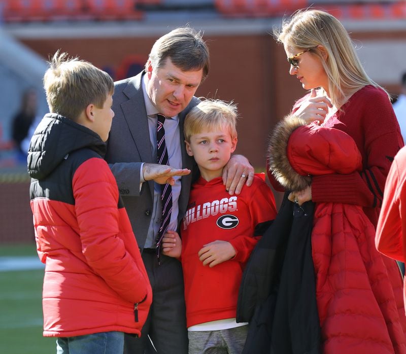 Georgia head coach Kirby Smart appears to coach up his sons Weston (left) and Andrew (right) as his wife Mary Beth looks on in Jordan-Hare Stadium as his team arrives to play Auburn in a NCAA college football game on Saturday, November 16, 2019, in Auburn.   Curtis Compton/ccompton@ajc.com