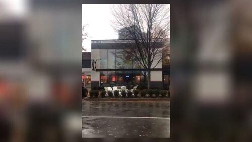 Four masked robbers armed with guns stormed into a Buckhead restaurant Saturday morning before pistol-whipping the manager and making off with more than $3,000 in cash, police said.