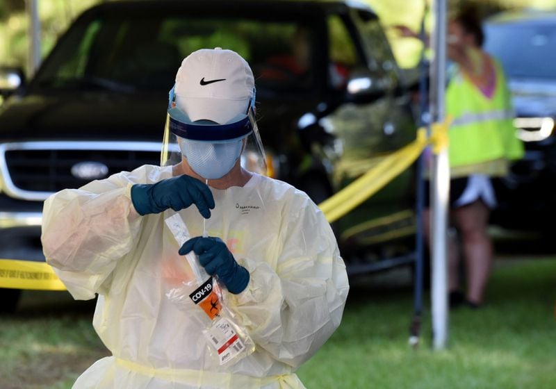 In this file photo, Cathy Webb, a licensed practical nurse, secures a COVID-19 test outside Glynn County Health Department in Brunswick, Ga.
Horne/RHORNE@AJC.COM