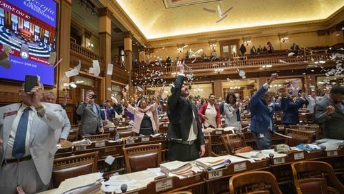 House members toss paper in the air at the conclusion of the legislative session on Sine Die, the last day of the General Assembly at the Georgia Capitol in Atlanta. Branden Camp/ For The Atlanta Journal-Constitution
