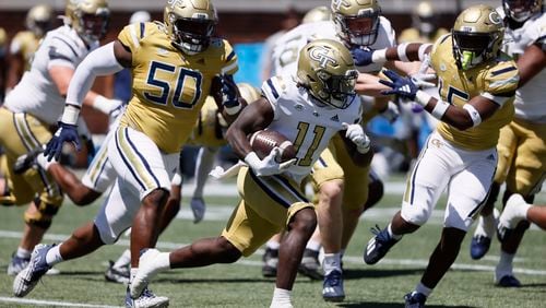 Georgia Tech running back Jamal Haynes (11) takes off ahead of Georgia Tech defensive lineman Ayo Tifase (50) in the first quarter during the Spring White and Gold game at Bobby Dodd Stadium at Hyundai Field In Atlanta on Saturday, April 13, 2024.   (Bob Andres for the Atlanta Journal Constitution)