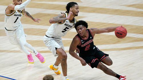 Georgia's Sahvir Wheeler (2) tries to get past Missouri's Mitchell Smith (5) and Xavier Pinson (1) in the first half of an NCAA college basketball game in the Southeastern Conference Tournament Thursday, March 11, 2021, in Nashville, Tenn. (AP Photo/Mark Humphrey)