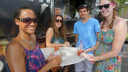 Tracy Cunningham (left), Julia Vaillancourt, Bogdan Gadidov and Marley Pruyn smile for the camera at the first black-owned Atlanta Food Truck Park.