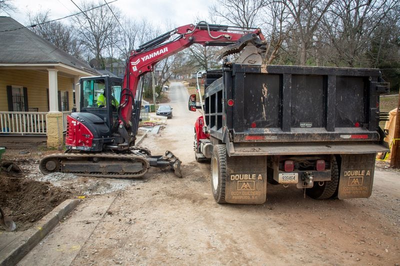 Lead-contaminated dirt is removed from a property in Vine City on Atlanta's Westside last week. Experts say it’s unclear exactly how dangerous levels of lead got in the soil beneath this historic Black community. (Steve Schaefer for The Atlanta Journal-Constitution)