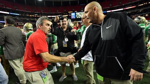 Rome coach John Reid (left) and Buford coach Jess Simpson shake hands after Rome beat Buford during the Class AAAAA state championship game at the Georgia Dome on Friday, December 9, 2016. Rome won 16-7 over the Buford. HYOSUB SHIN / HSHIN@AJC.COM
