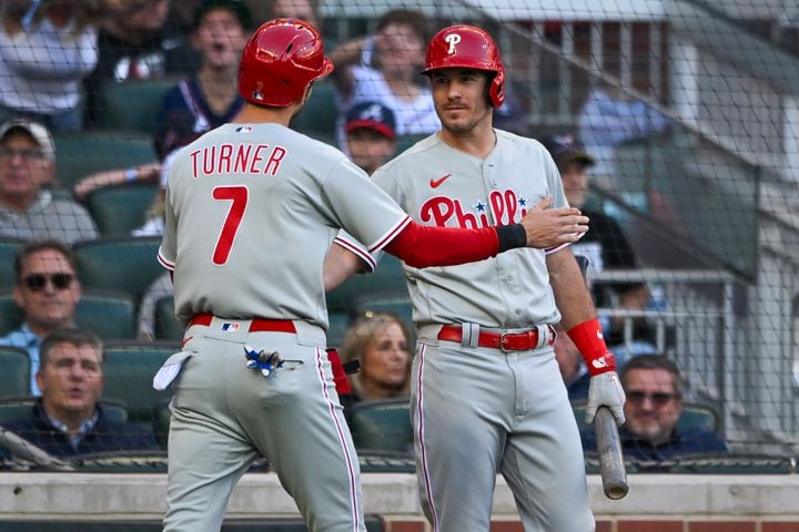 Philadelphia Phillies’ Trea Turner (7) is greeted after scoring against the Atlanta Braves on an RBI single by Alec Bohm during the first inning of NLDS Game 2 in Atlanta on Monday, Oct. 9, 2023.   (Hyosub Shin / Hyosub.Shin@ajc.com)