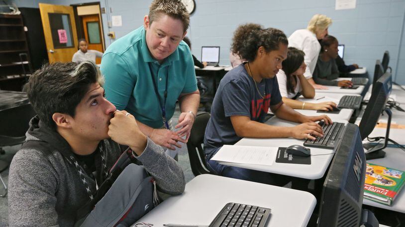 In this photo taken in September 2015, Cesar Gomez (left) gets some guidance from school counselor B.J. Smith as he works on his YouScience online assessment at the Marietta Performance Learning center. The Georgia Board of Education has approved a contract to make the career-aptitude test available in every high school. The data will let companies approach schools where students have attributes that match their needs, and offer internships, apprenticeships, job shadowing and other interactions that might set them on a career path they hadn’t considered BOB ANDRES / BANDRES@AJC.COM