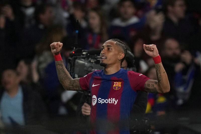 Barcelona's Raphinha celebrates after scoring his side's opening goal during the Champions League quarterfinal second leg soccer match between Barcelona and Paris Saint-Germain at the Olimpic Lluis Companys stadium in Barcelona, Spain, Tuesday, April 16, 2024. (AP Photo/Emilio Morenatti)