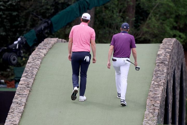 April 9, 2021, Augusta: Bernd Wiesberger, left, and Carlos Ortiz walk over the Ben Hogan Bridge to the twelfth green during the second round of the Masters at Augusta National Golf Club on Friday, April 9, 2021, in Augusta. Curtis Compton/ccompton@ajc.com
