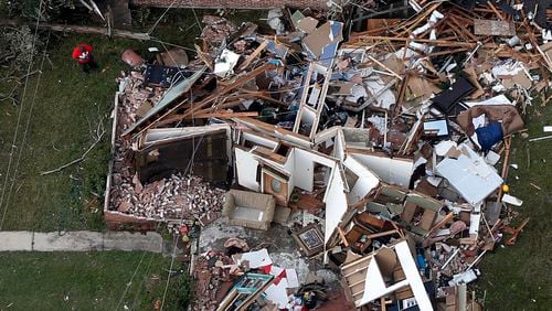 A man stands next to a destroyed home after a tornado tore through the eastern neighborhood of New Orleans, Tuesday, Feb. 7, 2017. Louisiana Gov. John Bel Edwards took an aerial tour before meeting New Orleans officials. He says the path of destruction is wide and varied. In eastern New Orleans, he says "it kind of bounced back and forth" across the busy Chef Menteur Highway. (AP Photo/Gerald Herbert)