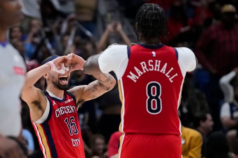 New Orleans Pelicans guard Jose Alvarado (15) celebrates with forward Naji Marshall (8) in the second half of an NBA basketball play-in tournament game in New Orleans, Friday, April 19, 2024. The Pelicans won 105-98. (AP Photo/Gerald Herbert)