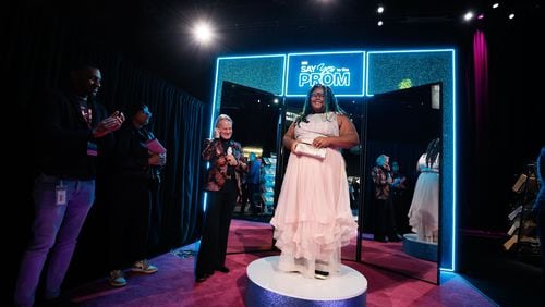 After getting advice from Monte Durham (left), host of the event “Say Yes to the Prom,“ McNair High School junior Bricelyn Armstead said "yes" to a pink gown at Warner Brothers Discovery's campus in Midtown on Tuesday, Feb. 6, 2024. (Miguel Martinez /miguel.martinezjimenez@ajc.com)