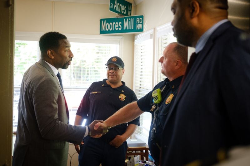 Mayor Andre Dickens (left) shakes hands with Lieutenant Randy McCord (right) while touring Atlanta Fire and Rescue Station 26 on Howell Mill Road NW in Atlanta on Monday, May 16, 2022.  (Arvin Temkar / arvin.temkar@ajc.com)