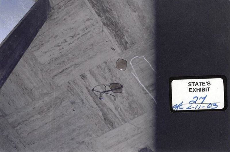 In this state’s exhibit photo, a pair of broken glasses are shown where they were found-inches from the body of Harold Swain in the vestibule of Rising Daughter Baptist Church in Camden County, Georgia in 1985.