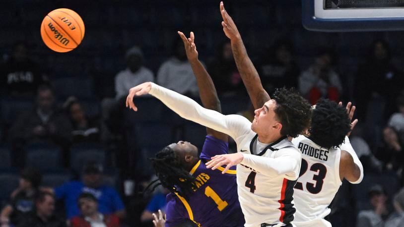 Georgia guard Jusaun Holt (4) rejects a shot by LSU guard Cam Hayes (1) as Braelen Bridges also defends in the first round of the SEC Tournament, Wednesday, March 8, 2023, in Nashville, Tenn. LSU won 72-67. (AP Photo/John Amis)