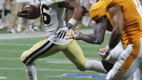 Georgia Tech quarterback TaQuon Marshall runs past Tennessee defenders for a first down on a scoring drive that ended with a touchdown during the second quarter in a NCAA college football game on Monday, Sept. 4, 2017, in Atlanta. (Curtis Compton/Atlanta Journal-Constitution via AP)