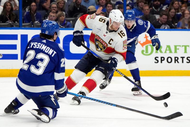 Florida Panthers center Aleksander Barkov (16) works between Tampa Bay Lightning defenseman Emil Lilleberg (78) and center Michael Eyssimont (23) during the third period in Game 3 of an NHL hockey Stanley Cup first-round playoff series, Thursday, April 25, 2024, in Tampa, Fla. (AP Photo/Chris O'Meara)