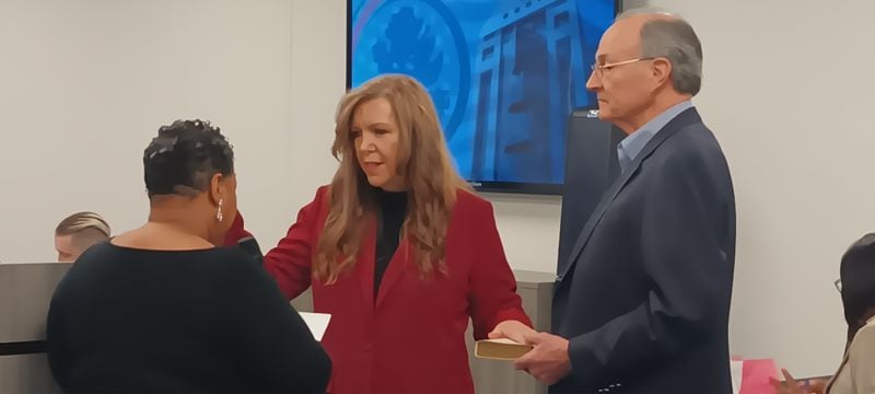 Julie Adams, shown being sworn in earlier this year as a member of the Fulton County Board of Registration & Elections, refused to certify the results of the March presidential primary because election staff was unable to provide all the documents she had sought. Neither did Michael Heekin, a fellow Republican member of the board who is shown holding the Bible for Adams' swearing-in ceremony.