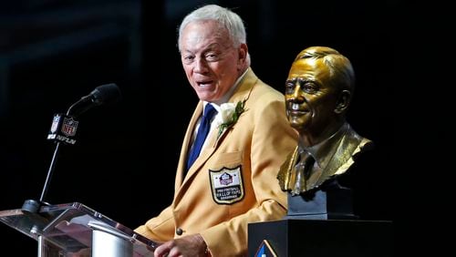 Dallas Cowboys owner Jerry Jones speaks next to a bust of him during inductions at the Pro Football Hall of Fame on Saturday, Aug. 5, 2017, in Canton, Ohio.