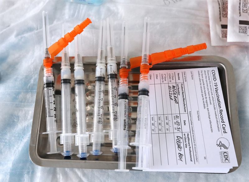 Moderna COVID-19 vaccines sit on a tray as they are prepared to be administered to health care workers at the DeKalb County COVID-19 BrandsMart USA drive-thru testing site on Jan. 7, 2021, in Doraville. (Curtis Compton / The Atlanta Journal-Constitution)