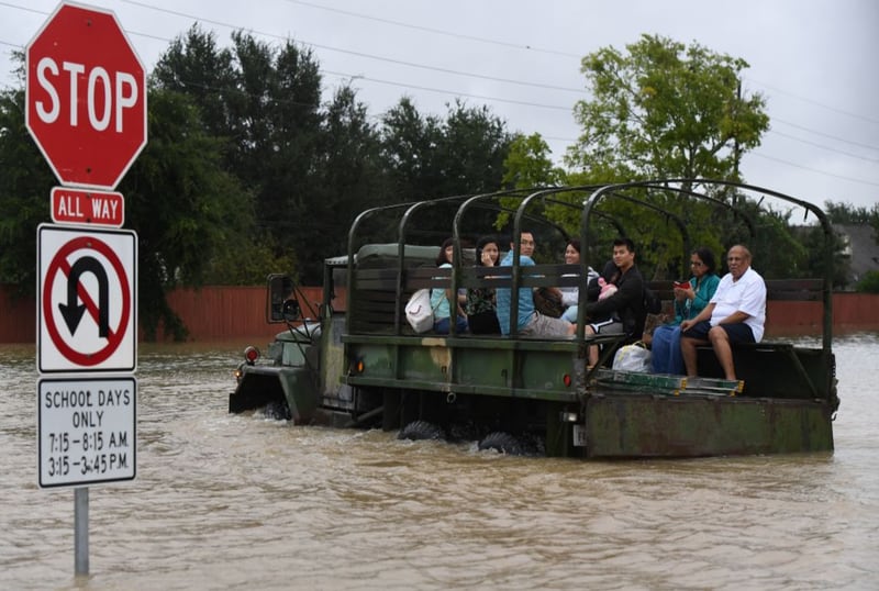 Local residents are evacuated by a military vehicle in Houston, Texas, after Hurricane Harvey caused widespread flooding. Floodwaters have breached a levee south of the city of Houston, officials said on Tuesday, Aug. 29., urging residents to leave the area immediately. 
