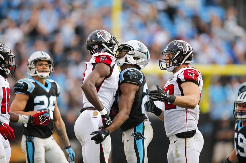 Carolina Panthers cornerback Josh Norman (24) and Atlanta Falcons wide receiver Julio Jones (11) exchange words after a play during an NFL football game at Bank of America Stadium in Charlotte, N.C. on Sunday, Dec. 13, 2015. (Chris Keane/AP Images for Panini)