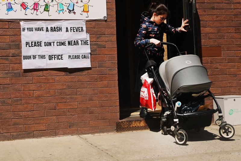 A sign warns people of measles in the ultra-Orthodox Jewish community in Williamsburg on April 10 in New York City. (Photo by Spencer Platt/Getty Images)