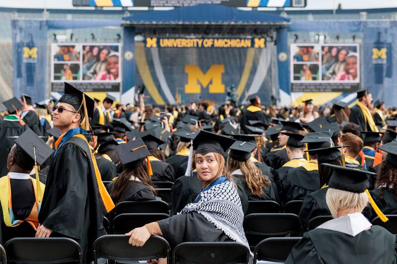 A graduate waits for the University of Michigan's Spring 2024 Commencement Ceremony to begin at Michigan Stadium in Ann Arbor on Saturday, May 4, 2024. (Jacob Hamilton/Ann Arbor News via AP)