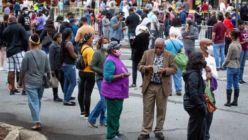 Long lines form outside the Cobb County Board of Elections and Registration offices on Monday for the first day of early voting.  STEVE SCHAEFER / SPECIAL TO THE AJC