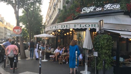 In this June 18, 2017 photo, Cafe de Flore is shown on a busy afternoon in Paris. It's the site where African-American novelist James Baldwin worked on his novel, Go Tell It on the Mountain." Travelers to Paris can create a different type of itinerary exploring African-American connections to the City of Light. Some of the United States' greatest black intellectuals and performers sought an escape here from the racism of 20th century America, and with a little homework, you can retrace their footsteps. (AP Photo/Russell Contreras)