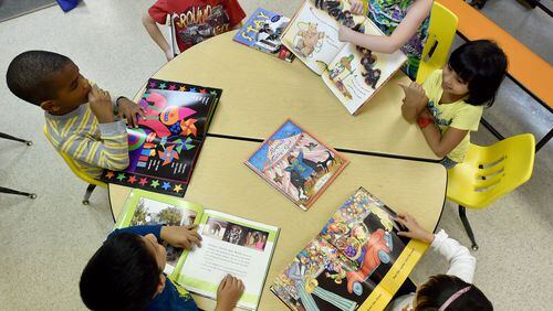 Pre-K students at The Sunshine House in Lilburn look at books during activities time in April 2015. The Gwinnett County school district is researching ways to help parents and day care centers better prepare students for kindergarten. AJC FILE PHOTO