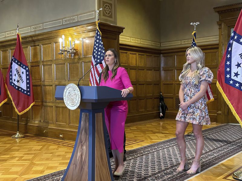 Arkansas Gov. Sarah Huckabee Sanders speaks at a news conference next to former Kentucky swimmer Riley Gaines at the state Capitol in Little Rock, Ark., Thursday, May 2, 2024. Sanders spoke before signing an executive order stating that Arkansas won't comply with new federal regulations intended to protect the rights of transgender students. (AP Photo/Andrew DeMillo)