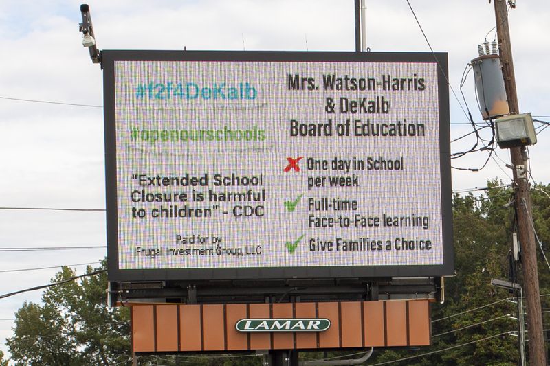 A billboard calling on DeKalb school distict leaders to offer a more robust in-person learning option, paid for by a group of DeKalb County parents, is seen on DeKalb Industrial Way in Decatur, Georgia, on Oct. 16, 2020. (Rebecca Wright for the Atlanta Journal-Constitution)