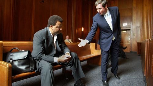 In 2005, inside a Massachusetts courtroom, Hawks General Manager Billy Knight, left, refuses to shake hands with Steve Belkin as members of the Atlanta Spirit fought for legal control of the team. (AP Photo/Bizuayehu Tesfaye)