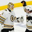 Boston Bruins goaltender Jeremy Swayman (1) and David Pastrnak (88) celebrate after defeating the Toronto Maple Leafs in Game 3 of an NHL hockey Stanley Cup first-round playoff series in Toronto on Wednesday, April 24, 2024. (Frank Gunn/The Canadian Press via AP)