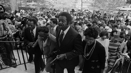 Ralph David Abernathy (cneter) and his wife Juanita (right) attend the dedication of the West Hunter Street Baptist Church in 1973.